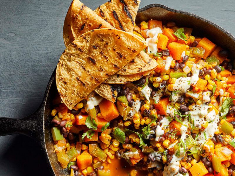 Mexican Hash with Lime Crema in a cast iron skillet with tortillas