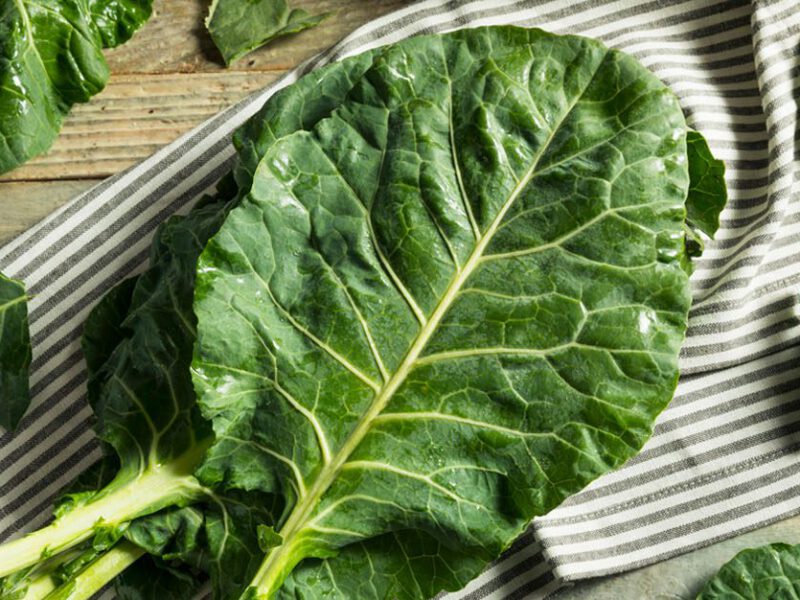 Collard Greens on a dish towel and cutting board