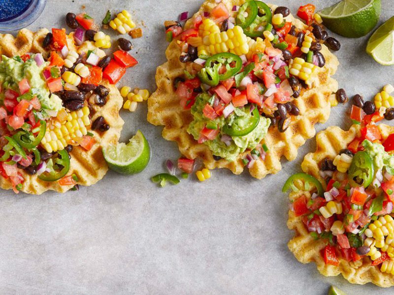 Tamale Waffles with Black Bean Hash on a grey countertop
