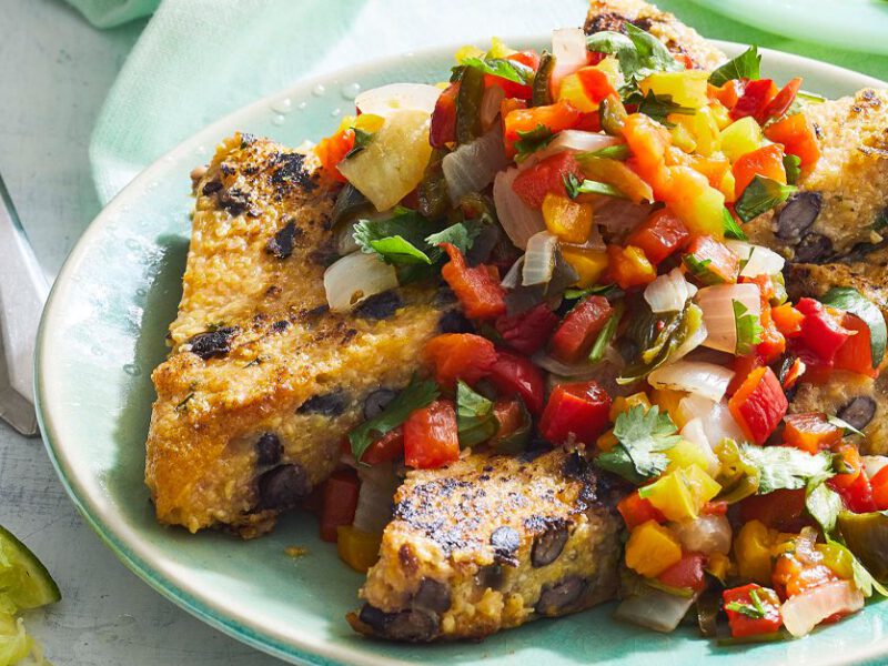 Black Bean Polenta Cakes with Pepper-Cilantro Salsa on a green plate