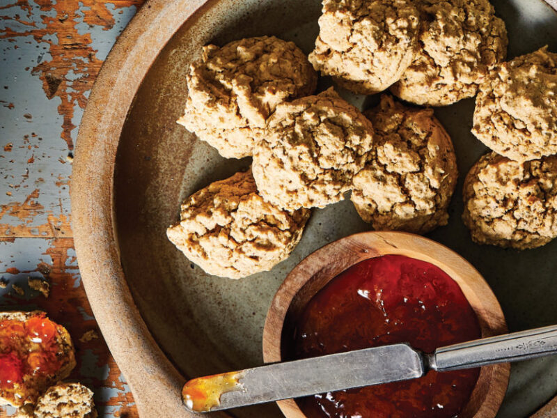 Ann's Short Flax Biscuits on a ceramic plate with a small wooden bowl of jam