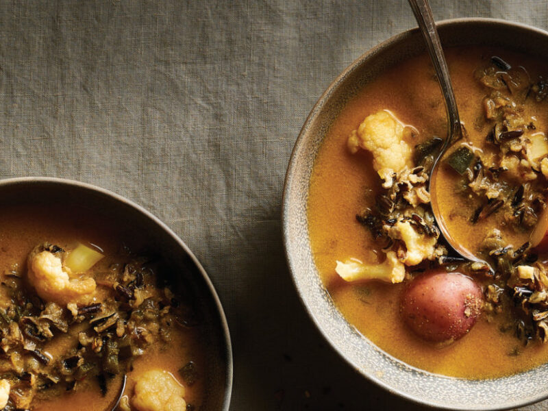 Two bowls of Chipotle-Potato Wild Rice Soup on a natural brown tablecloth