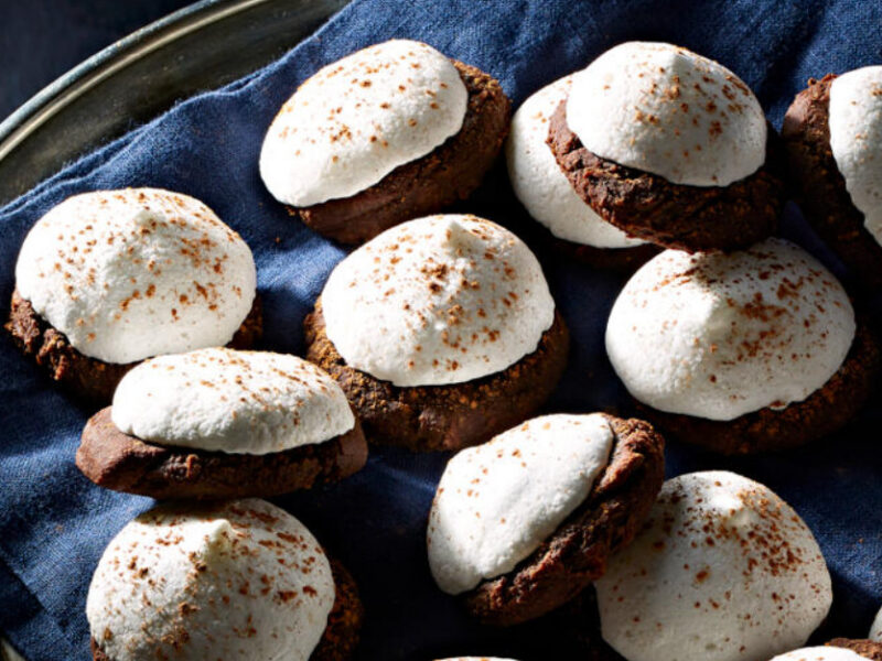 Chocolate Mint Kiss Cookies on a blue napkin on a silver serving tray