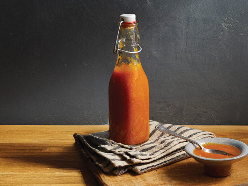 A bottle of Curried Mango Ketchup on a folded kitchen towel
