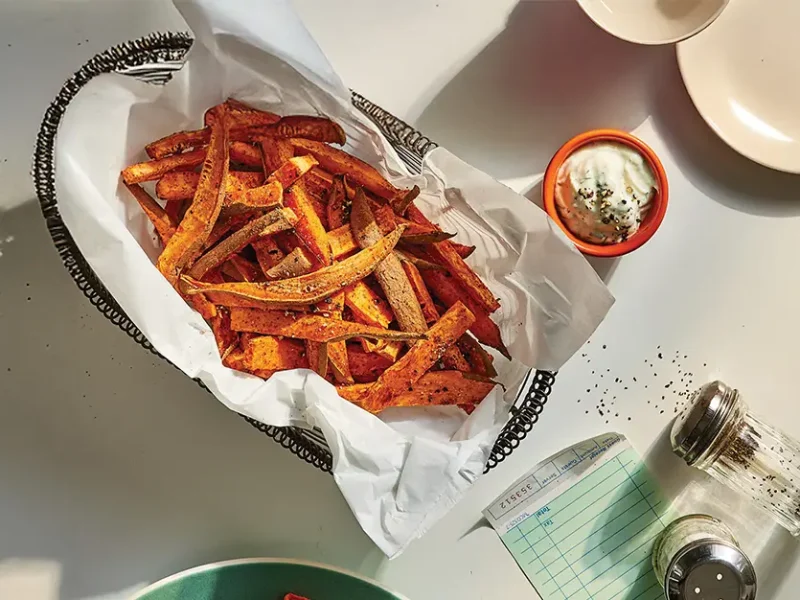 Smoky Sweet Potato Fries in a basket with a small bowl of sweet potato fries Dipping Sauce