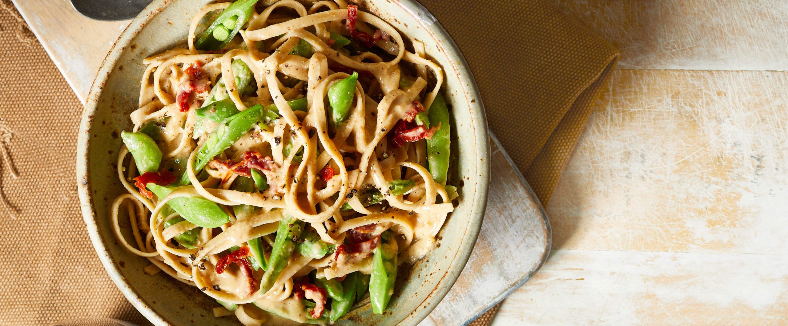 White Bean Fettuccine Alfredo with Peas and Sun-Dried Tomatoes